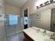 Bathroom with a vanity, large mirror, and walk-in shower at 7953 Sea Pearl Cir, Kissimmee, FL 34747