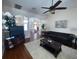 Living room with hardwood floors, leather sofas, and a view into another living area at 7953 Sea Pearl Cir, Kissimmee, FL 34747
