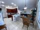 Kitchen with breakfast bar, table and chairs, and views into living room at 7953 Sea Pearl Cir, Kissimmee, FL 34747