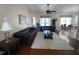 Bright living room with hardwood floors, a large sofa, and access to dining area at 7953 Sea Pearl Cir, Kissimmee, FL 34747