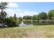 Serene lake view with a wooden dock, lush greenery, and a tranquil atmosphere at 2913 Eagle Lake Dr, Orlando, FL 32837