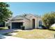 House exterior with a two-car garage and neatly kept lawn at 2726 Randal Way, Kissimmee, FL 34743
