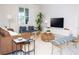 Living room with brown leather sofa, blue armchairs, and a large TV at 4577 Target Blvd, Kissimmee, FL 34746