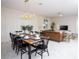 Modern dining room with a farmhouse style table and view of the living room at 4577 Target Blvd, Kissimmee, FL 34746