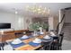Open concept dining room with a wood table and access to the kitchen and living room at 4577 Target Blvd, Kissimmee, FL 34746