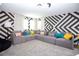 Spacious game room with sectional sofa and geometric wall at 4577 Target Blvd, Kissimmee, FL 34746