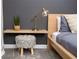 Bedroom with floating shelves, lamp, and comfortable seating at 4577 Target Blvd, Kissimmee, FL 34746