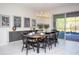 Bright dining room with a wood table, black chairs, and a view of the pool at 4577 Target Blvd, Kissimmee, FL 34746
