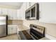 Modern kitchen features stainless steel appliances and white cabinets at 2204 Mac Blvd, Eagle Lake, FL 33839