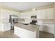 Modern kitchen with white cabinets, quartz countertops, and stainless steel appliances at 2204 Mac Blvd, Eagle Lake, FL 33839