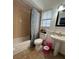 Clean bathroom with tub, toilet, and pedestal sink at 866 Crows Bluff Ln, Sanford, FL 32773