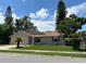 Tan one-story house with a two-car garage and landscaping at 866 Crows Bluff Ln, Sanford, FL 32773