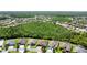 Aerial view showing a house nestled in a wooded area of a residential community at 465 Villa Park Rd, Poinciana, FL 34759