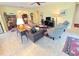 Bright living room with comfortable seating, and views to kitchen and entryway at 465 Villa Park Rd, Poinciana, FL 34759