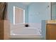 Bathroom with corner bathtub and window at 2912 Willow Oak Ct, Kissimmee, FL 34744