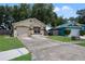 Tan house with a garage and solar panels at 2912 Willow Oak Ct, Kissimmee, FL 34744