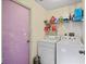 Laundry room with washer, dryer, and shelving at 2912 Willow Oak Ct, Kissimmee, FL 34744
