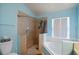 Bathroom with shower, tub, and window at 2912 Willow Oak Ct, Kissimmee, FL 34744