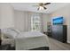 Bright bedroom with a large bed, dresser, and window coverings at 13103 Mulberry Park Dr # 8211, Orlando, FL 32821