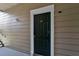 Exterior entry door to condo unit, dark green with white trim at 13103 Mulberry Park Dr # 8211, Orlando, FL 32821