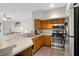 Modern kitchen features stainless steel appliances and wood cabinets at 13103 Mulberry Park Dr # 8211, Orlando, FL 32821
