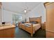 Large main bedroom with a king-size bed and wood furniture at 5014 Laguna Bay Cir # 108, Kissimmee, FL 34746