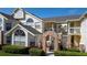 Two-story condo building with brick accents and landscaping at 5014 Laguna Bay Cir # 108, Kissimmee, FL 34746