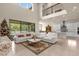 Open living area features high ceilings, a sectional sofa, and views to pool at 7650 Wandering Way, Orlando, FL 32836