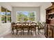 Formal dining room with large window and seating for eight at 7650 Wandering Way, Orlando, FL 32836