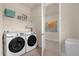 Bright laundry room, complete with washer, dryer, and shelving at 7650 Wandering Way, Orlando, FL 32836