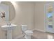 Small bathroom with pedestal sink and toilet at 7650 Wandering Way, Orlando, FL 32836