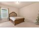 Spacious bedroom with plush carpeting and large window at 7650 Wandering Way, Orlando, FL 32836