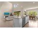 Open concept kitchen with island, stainless steel appliances, and views to Gathering room at 7650 Wandering Way, Orlando, FL 32836