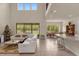 Two-story living room with sectional sofa, high ceilings, and views to kitchen and pool at 7650 Wandering Way, Orlando, FL 32836