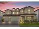 Two-story house with three car garage and landscaped yard at 7650 Wandering Way, Orlando, FL 32836
