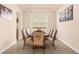Formal dining room with wood table and floral chairs at 7650 Wandering Way, Orlando, FL 32836
