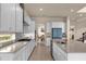 Bright kitchen boasts white cabinets, stainless steel appliances, and an open floor plan at 7650 Wandering Way, Orlando, FL 32836