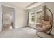 Bright bedroom with a hanging chair and access to bathroom at 7650 Wandering Way, Orlando, FL 32836