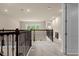 Upstairs hallway with carpeted floors and open railing at 7650 Wandering Way, Orlando, FL 32836