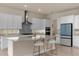 Island kitchen with white cabinets, stainless steel appliances, and quartz countertops at 7650 Wandering Way, Orlando, FL 32836