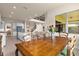 Open dining area with wooden table and chairs, overlooking the kitchen at 7650 Wandering Way, Orlando, FL 32836
