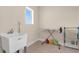 Laundry room with utility sink, ironing board, and drying rack at 7650 Wandering Way, Orlando, FL 32836