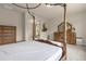 Main bedroom with dresser, large bed, and sitting area at 7650 Wandering Way, Orlando, FL 32836