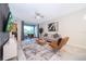 Living room with balcony access, comfortable seating and a large TV at 3131 Paradox Cir # 108, Kissimmee, FL 34746