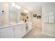 Double vanity bathroom with white cabinets and a shower at 3131 Paradox Cir # 108, Kissimmee, FL 34746