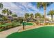 Community mini golf course with palm trees and landscaping at 4825 Clock Tower Dr, Kissimmee, FL 34746