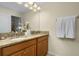 Double vanity bathroom with granite countertop and towels at 4825 Clock Tower Dr, Kissimmee, FL 34746