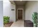 Townhouse entry with dark brown door and neutral walls at 4825 Clock Tower Dr, Kissimmee, FL 34746