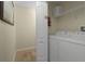 Convenient laundry room with washer, dryer, and shelving at 4825 Clock Tower Dr, Kissimmee, FL 34746