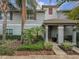 Townhouse with a covered entryway and landscaping at 4825 Clock Tower Dr, Kissimmee, FL 34746
